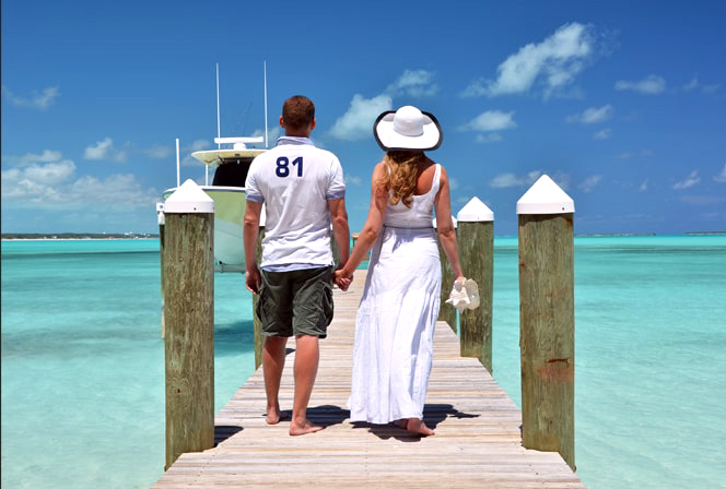 Young successful couple walking on a pier